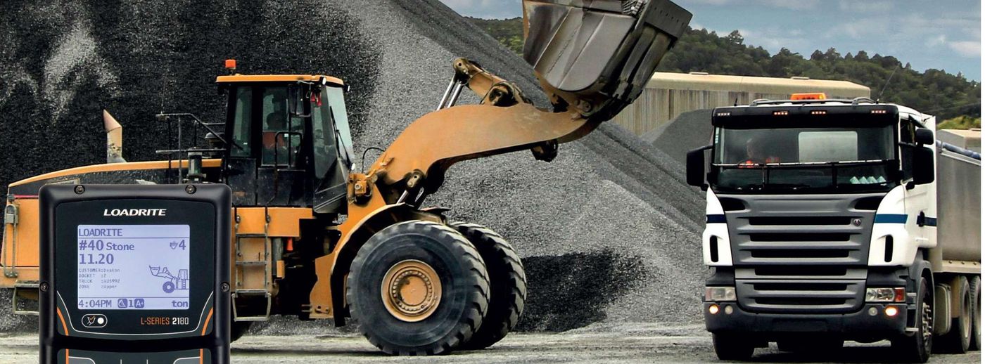 Loadrite L2180 wheel loader scale indicator with loader and truck at a stockpile